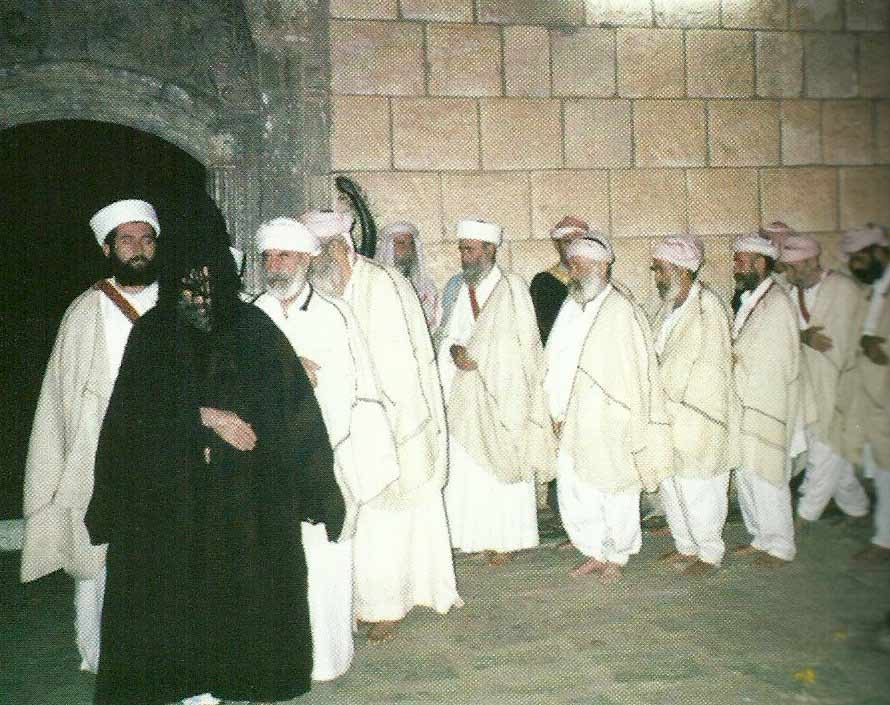 Fourteen dancers  dressed  in white, the color of purity...are led by the head of the Faqirs, who dresses in black