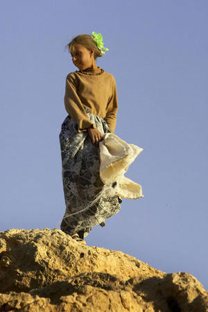 A Yezidi girl with light colored hair stands on Mount Sinjar, 250 miles (404 kilometers) northwest of Baghdad, Iraq, Monday, Sept. 19, 2005. (Jacob Silberberg, AP)